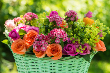Basket with many colorful summer flowers