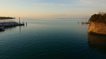 The blue waters of Lake Garda stretching up to the horizon. A popular destination for turistic trips to Italy.