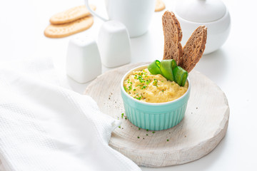 Scrambled eggs with chives and bread, white background