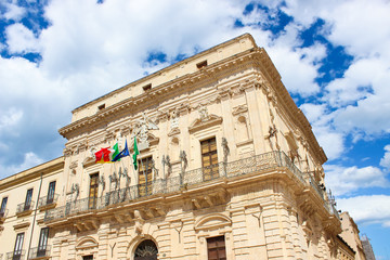 Detail of beautiful Vermexio Palace in Syracuse, Sicily, Italy. The historical building serves nowadays as a town hall. Located on famous Ortygia Island close to Syracuse Cathedral. Popular site