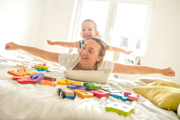 Mother and son enjoying the day together while having fun at home