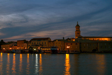 Nocturnal view of waterfront town of Krk. Summer seascape of Adriatic sea. Island Krk, Croatia.-