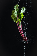 gourd on a black background with water drops