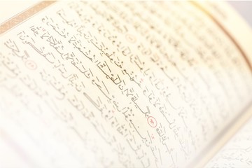 Islamic Book Koran with rosary on grey