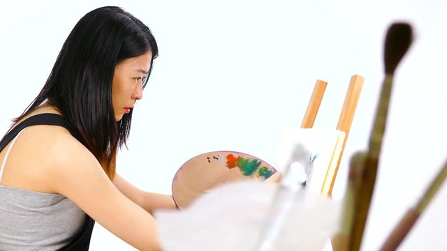 Artist painting at easel foreground elements
