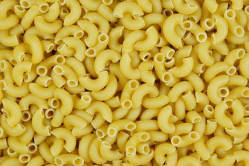 Pasta background, delicious popular food. Pasta — a product of dried wheat dough with a round cross section. Pasta is widely used in Italian cuisine, served with tomato sauce, boiled soups.