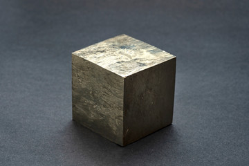 Isolated Pyrite cubic crystal. An iron sulfide mineral also known as fool's gold. Cubic golden shaped natural pattern.