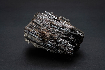 Piece of Hubnerite mineral from Pasto Bueno, Peru. A mineral consisting of manganese tungsten oxide with black monoclinic prismatic submetallic crystals with fine striations. - obrazy, fototapety, plakaty