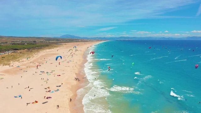 Aerial view. a large beach filled with kite surfers in tarifa, Spain.