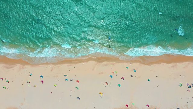 Aerial view. Ocean waves, kitesurfing from the sky in blue ocean.