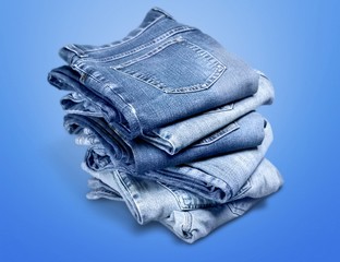 Pile of blue jeans over white background
