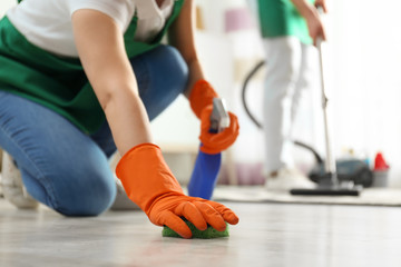 Woman cleaning floor with sponge, closeup. Space for text