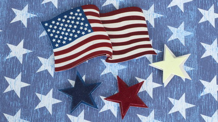 Obraz premium American flag and red white and blue stars laying flat on a blue and white star background