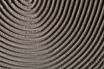 Fototapeta na wymiar Lined grey concrete as background, top view. Tile installation