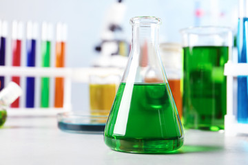 Conical flask and other glassware on table in chemistry laboratory. Space for text