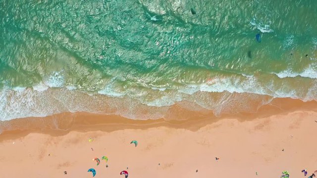 Aerial view. Ocean waves, kitesurfing from the sky in blue ocean.