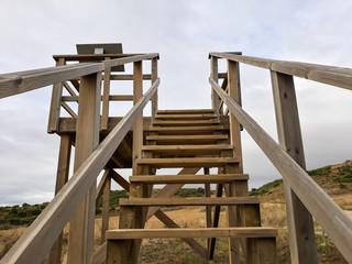 Wooden staircase in a viewpoint of Andelos overlooking the sky. Andelos was a Roman city now in ruins. Located in the town of Mendigorria, Navarra, Spain.