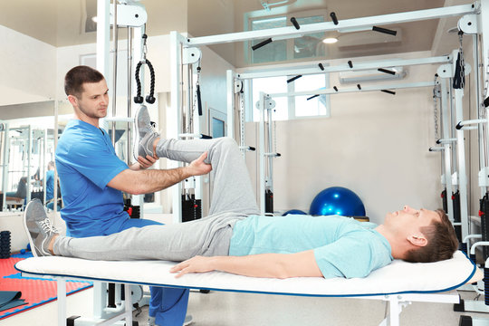 Physiotherapist working with patient in rehabilitation center