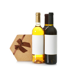 Bottles of wine and gift box on white background