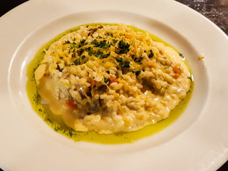 risotto with vegetables on a plate of white ceramics already prepared and served on the table ready to eat.