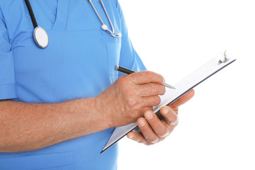 Male doctor in scrubs with stethoscope and clipboard isolated on white, closeup. Medical staff