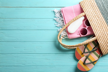 Flat lay composition with beach accessories on color wooden background. Space for text
