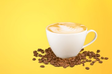 Coffee mug with cream and grains on the yellow table