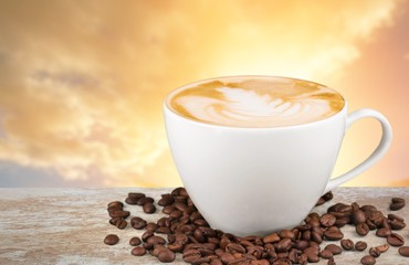 Coffee mug with cream and grains on the wooden table