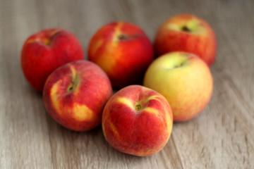 Fototapeta na wymiar Fresh peaches on a wooden table. Selective focus.