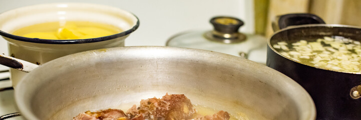 Old vintage saucepans of food in the kitchen