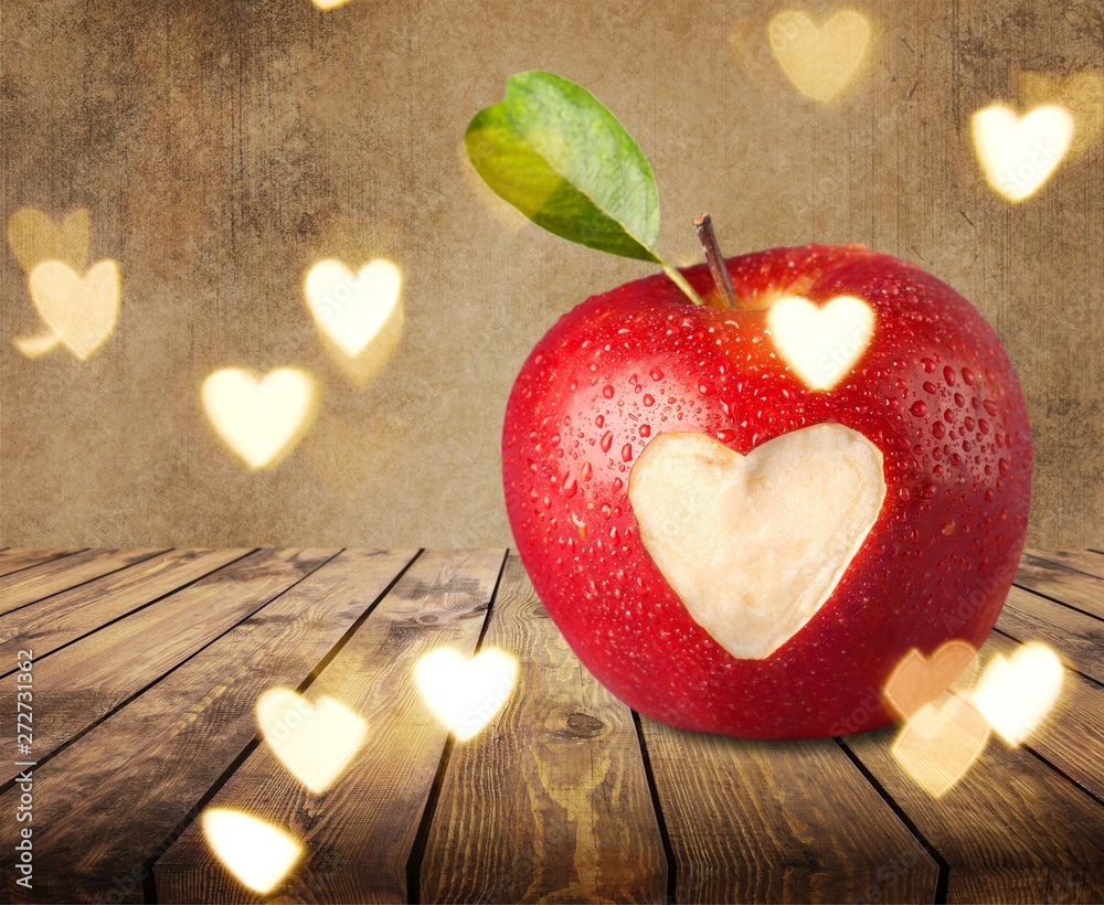 Wall mural red apple with a heart shaped