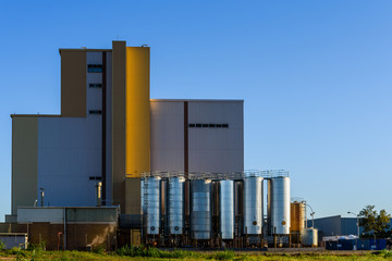 Valencia, Spain - May 29, 2019: Industrial factory with large metal tanks to store liquids and...