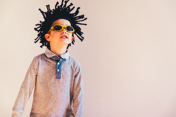 Child with cheerful wig posing, isolated white background copy space.