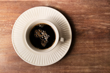 Coffee bubbles cup on plate with Africa map shape.