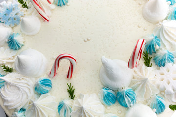Winter Holiday frosted cake with sugar stars, candy canes and snowflakes