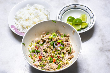 Spicy Beaf Salad with Lemongrass with rice and lemon on table. Thai Food Menu Style.
