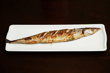 Grilled pacific saury fish on plate 
