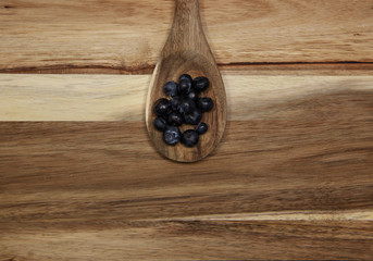 blueberries on a wooden surface 