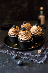 four cupcakes with blueberry