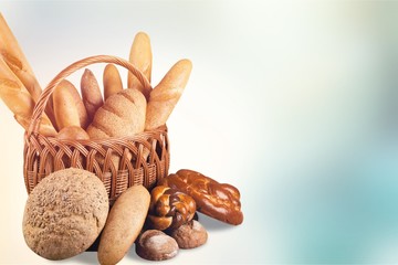 Composition with bread  in wicker basket isolated on white