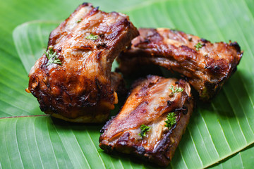 bbq pork ribs grilled with herbs spices served on banana leaf - Roasted barbecue pork spare rib sliced