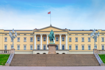 Front view of the Royal Palace  and The equestrian statue of King Karl III Johan of Norway and Sweden stand in front of and blue sky in morning summer. Oslo, Norway. - 272740536
