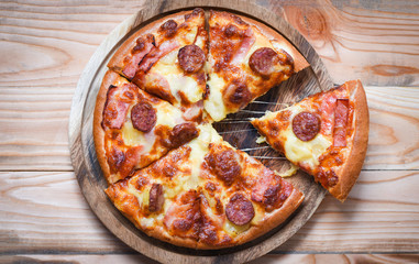 Pizza on wooden tray top view / delicious tasty fast food italian traditional pizza cheese