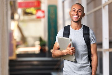 Male student with  backpack on  background