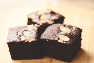 brownies cake on the table - chocolate cake slice with nut on wooden background