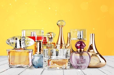 Aromatic Perfume bottles on white wooden desk at wooden background
