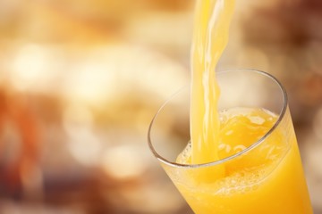 Orange juice glass on background