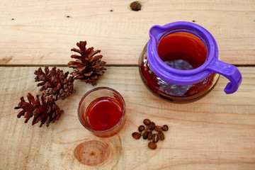 coffee drinks served on wooden tables with small glasses, with added pine decorations