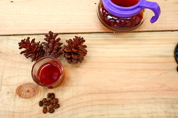 coffee drinks served on wooden tables with small glasses, with added pine decorations