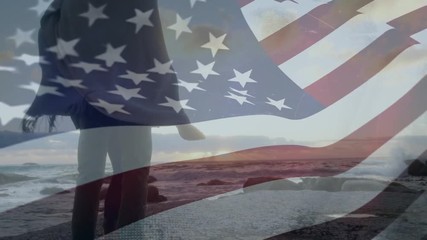 American couple watching the sunset at a beach - Powered by Adobe